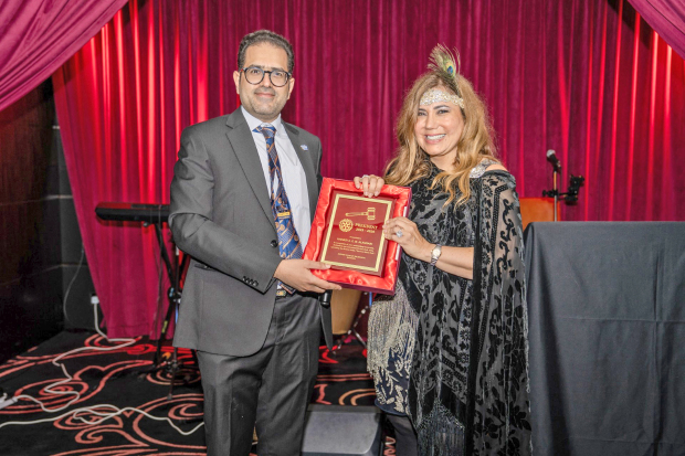 <p><em><strong>Ms Al Ansari receives a plaque from deputy district governor Faisal Juma for her service for the term 2025-26.</strong></em></p>
<p>The Rotary Club of Salmaniya (RCS) hosted a sponsor appreciation night at The Legacy at Bahrain Financial Harbour. Guests enjoyed a Gatsby-themed evening with dinner and fun activities, including a raffle and a live band. Three winners were selected for the best-dressed competition. RCS president Hanadi Al Ansari thanked sponsors, members and friends, and presented mementos to the club&rsquo;s supporters. Left, guests dressed in their best. Right, Ms Al Ansari receives a plaque from deputy district governor Faisal Juma for her service for the term 2025-26.</p>